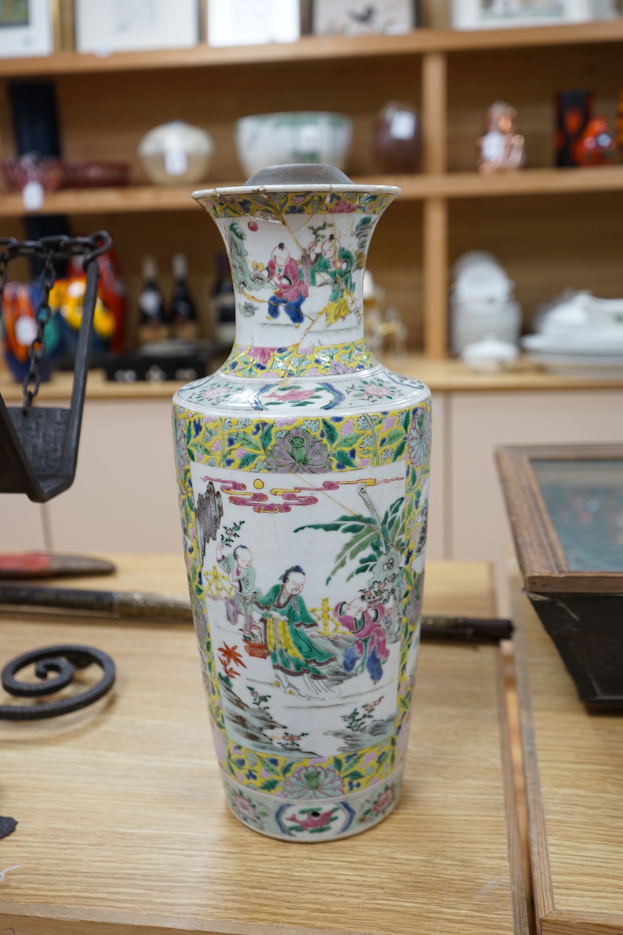 A 19th century Chinese famille rose porcelain vase enamelled with figures and flowers, converted to a lamp base, 43cm high. Condition - poor